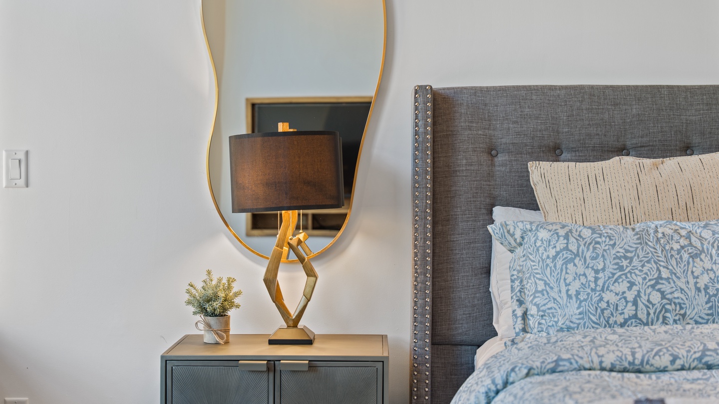 Sink into crisp linens and plush pillows in your thoughtfully appointed bedroom. Elegant touches and warm lighting create your peaceful retreat after a day of exploring.