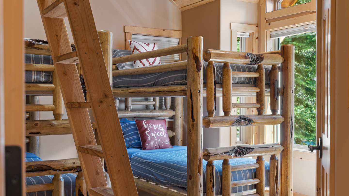 Cozy up in this rustic bunk room with handcrafted log furniture and natural wood accents—perfect for your group or family adventure in the mountains.