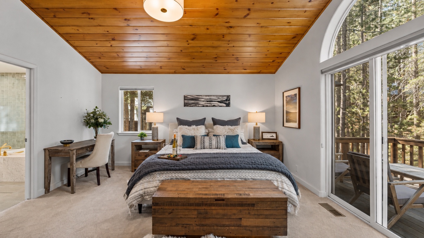Wake up to the serenity of towering pines framed by your private balcony. The warm wood ceiling and plush bedding invite you to unwind in comfort, surrounded by nature's beauty.