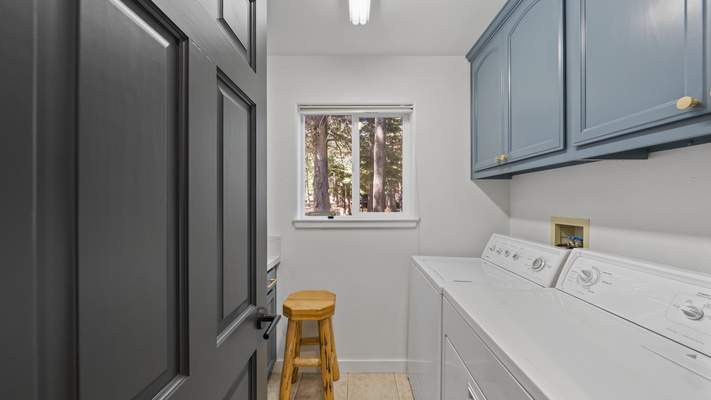 Your laundry routine gets a refresh in this bright, organized space with full-size appliances and generous cabinetry to keep everything tidy.