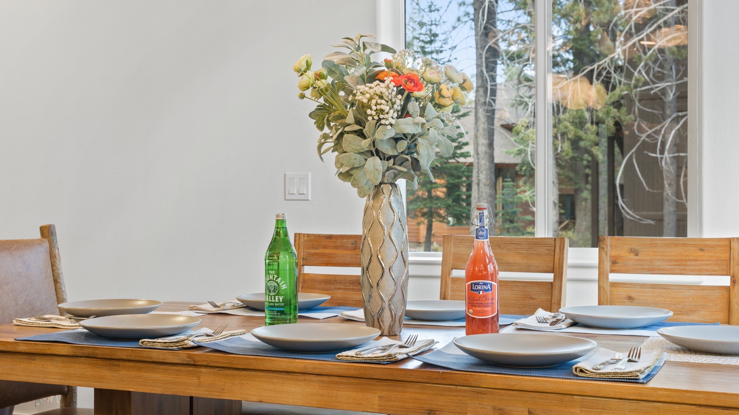 Gather around your private dining table, perfectly set and ready for memorable meals together. Through the windows, tall pines frame your mountain retreat.