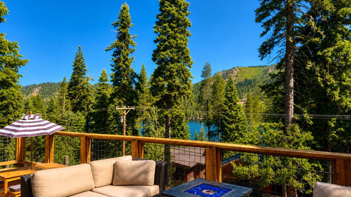 Relax on your private deck overlooking alpine forests and a pristine mountain lake. The outdoor seating area and fire table are perfect for unwinding after a day of adventure.
