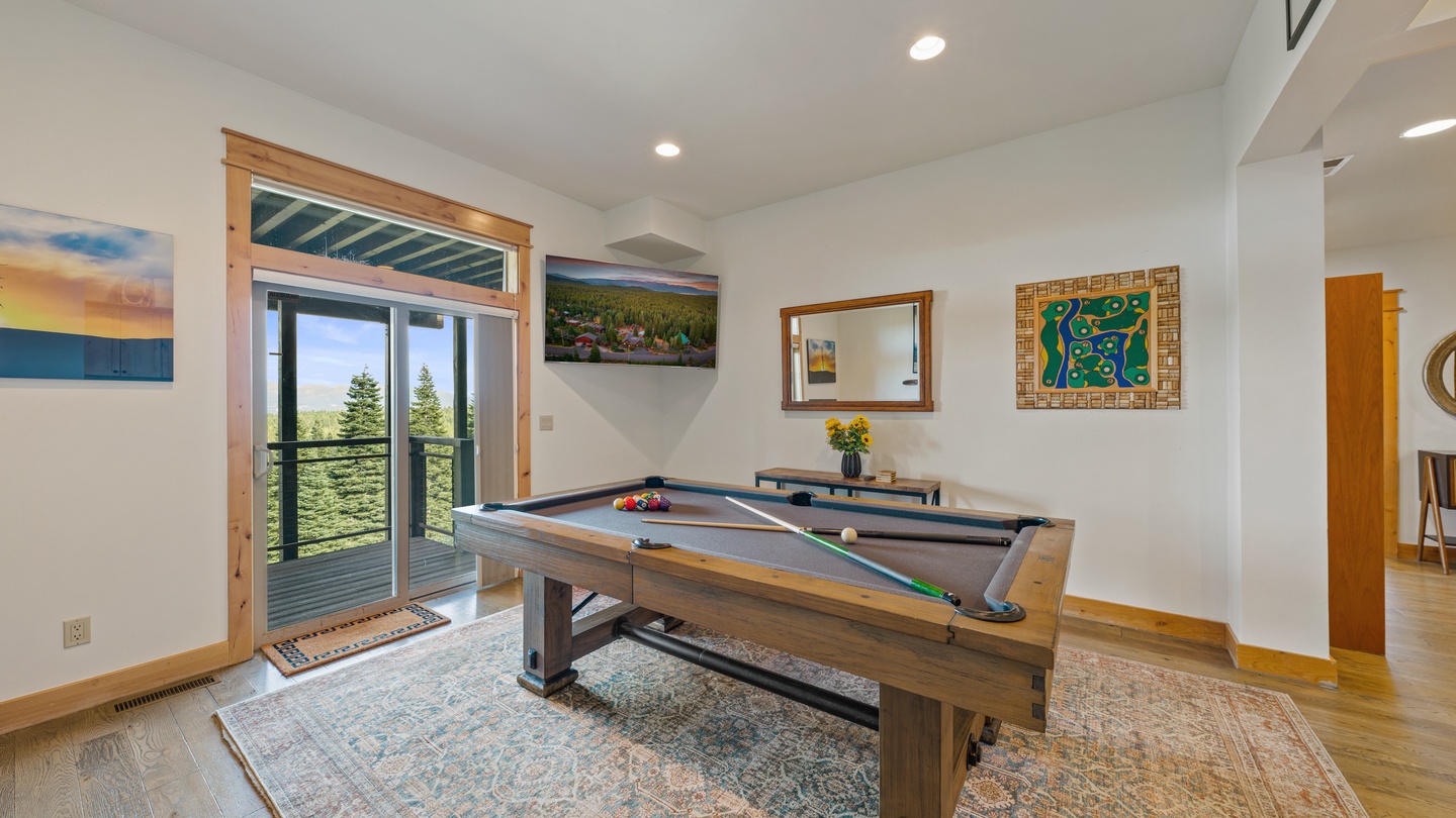 Enjoy your own private game room with a full-size pool table and expansive views through sliding glass doors. Step outside to the deck or play a few rounds indoors—either way, relaxation awaits.