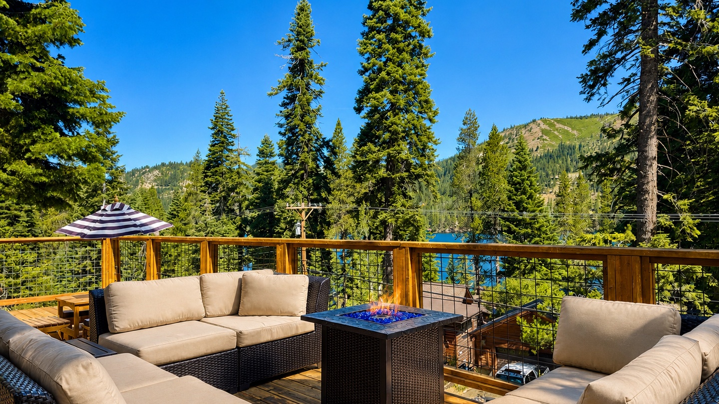 Sink into plush seating on your private deck, where mountain forest views stretch endlessly before you. The glowing fire table sets a cozy scene for alpine evenings under open skies.