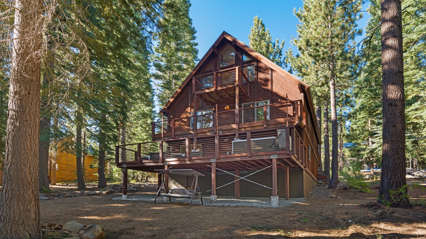 This charming multi-level mountain cabin nestled among towering pines offers a warm, inviting escape surrounded by natural beauty and fresh alpine air.