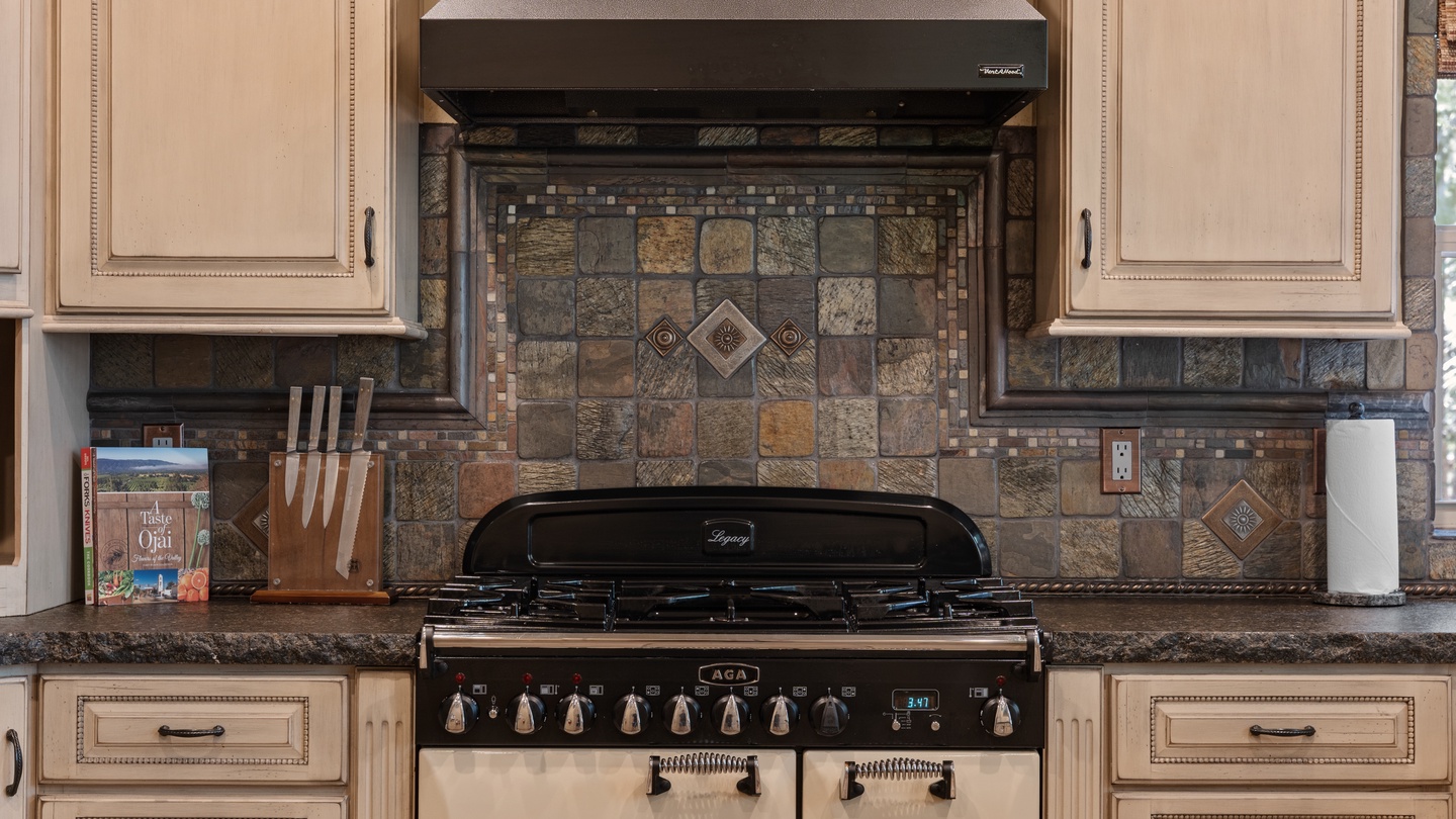 Step into your gourmet kitchen, where rustic elegance meets modern convenience—featuring a stunning vintage-style range, custom tile backsplash, and granite countertops ready for your culinary creations.