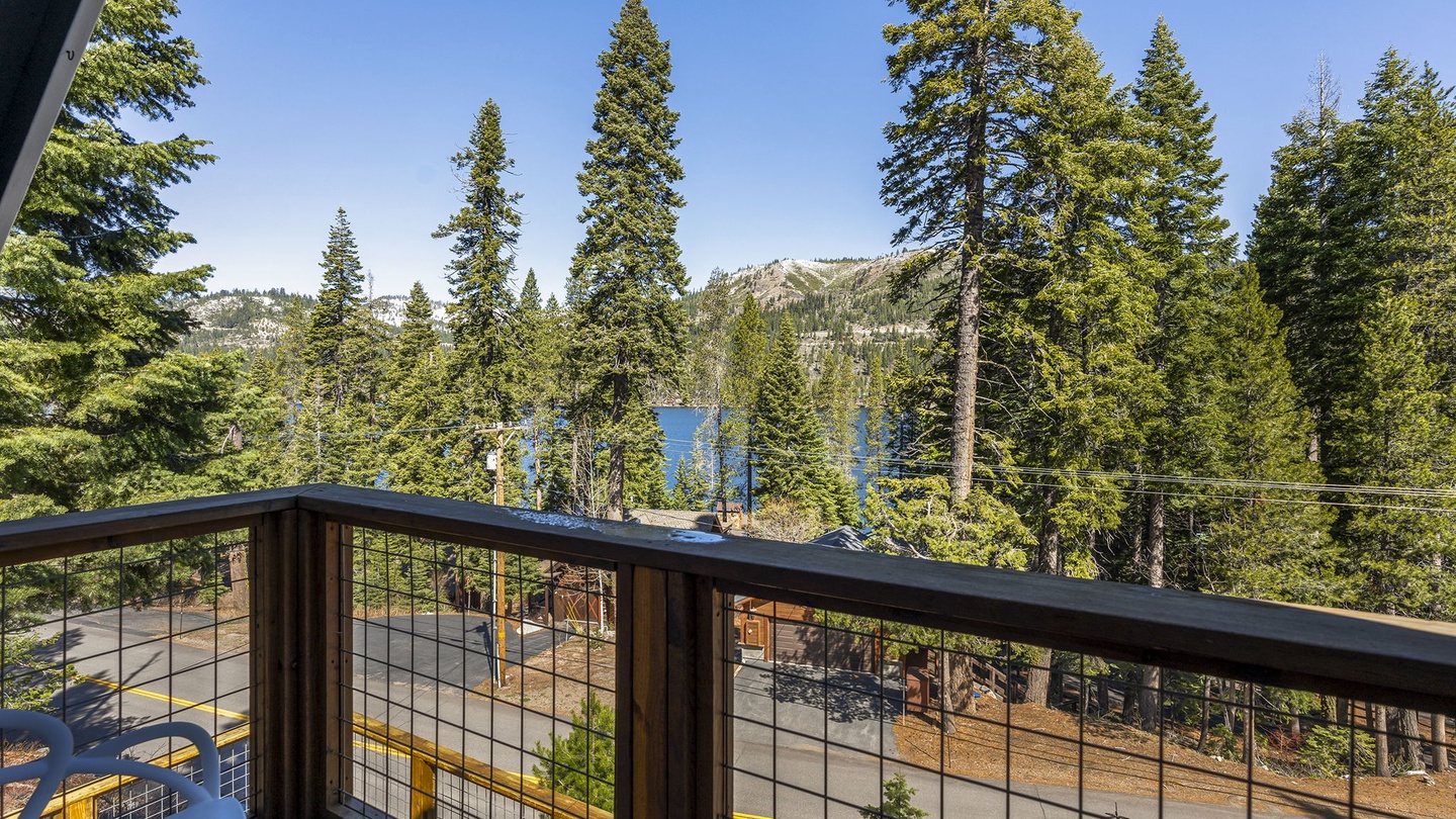 Step onto your private balcony and breathe in the fresh mountain air while taking in stunning views of towering pines and distant lake peaks.