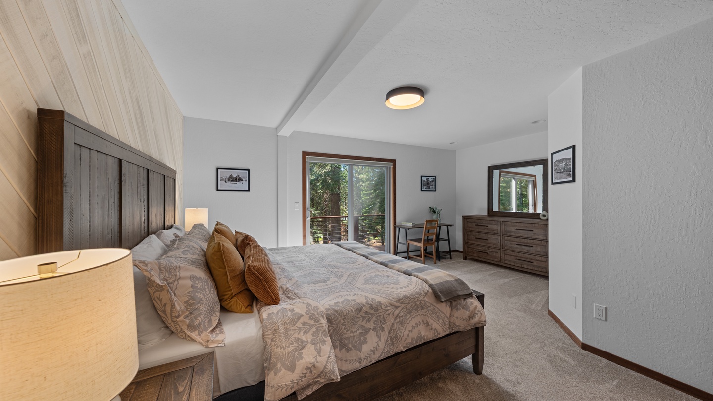 Wake up in your peaceful bedroom, where soft natural light filters through glass doors to a private deck nestled among the trees. The mountain retreat you've been dreaming of awaits.