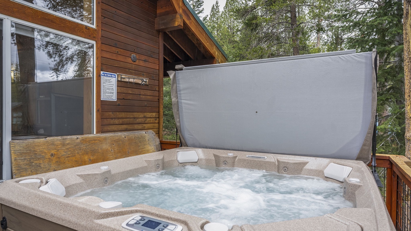 Soak in your private hot tub surrounded by towering pines, letting the mountain air refresh your senses as you unwind.