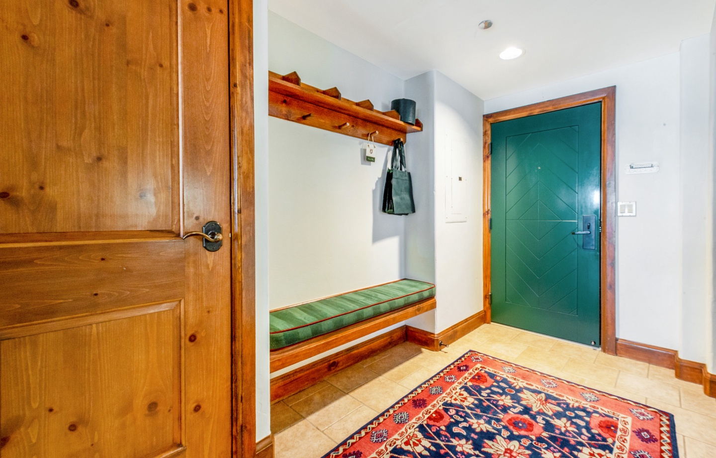 Step inside your cozy entryway, where warm wood accents and a welcoming bench await. Hang your coat, slip off your shoes, and settle in—your mountain retreat begins here.
