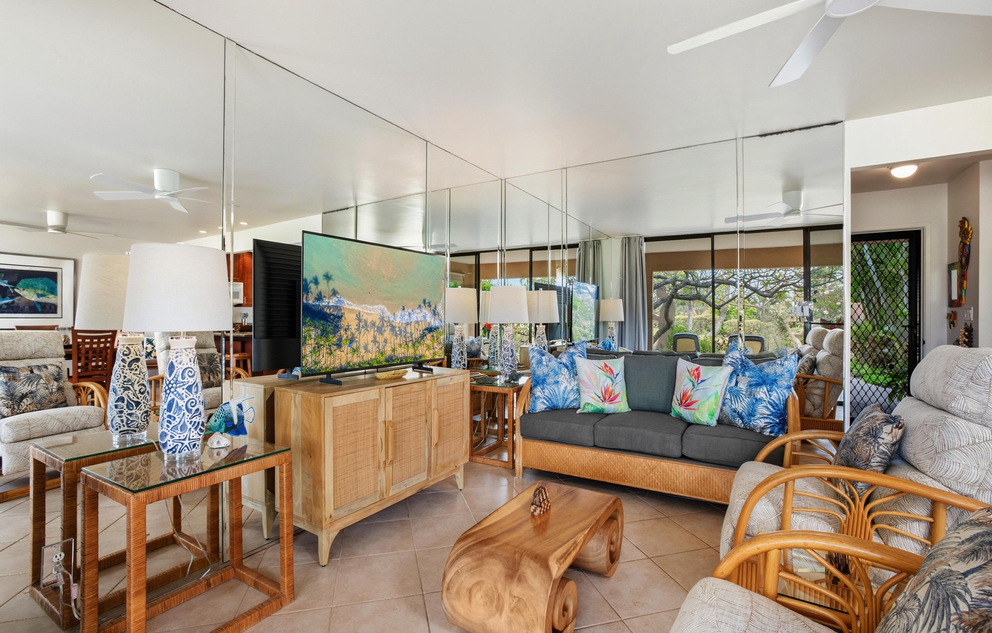 Step into your bright, open-plan living space where tropical breezes flow through and colorful art sets a relaxed, island-inspired mood. Unwind on plush seating while enjoying views of lush greenery outside.