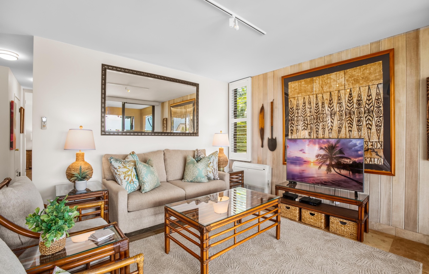 Sink into the plush sofa surrounded by tropical accents and warm island-inspired decor. The open layout and natural light create an inviting retreat for your perfect getaway.