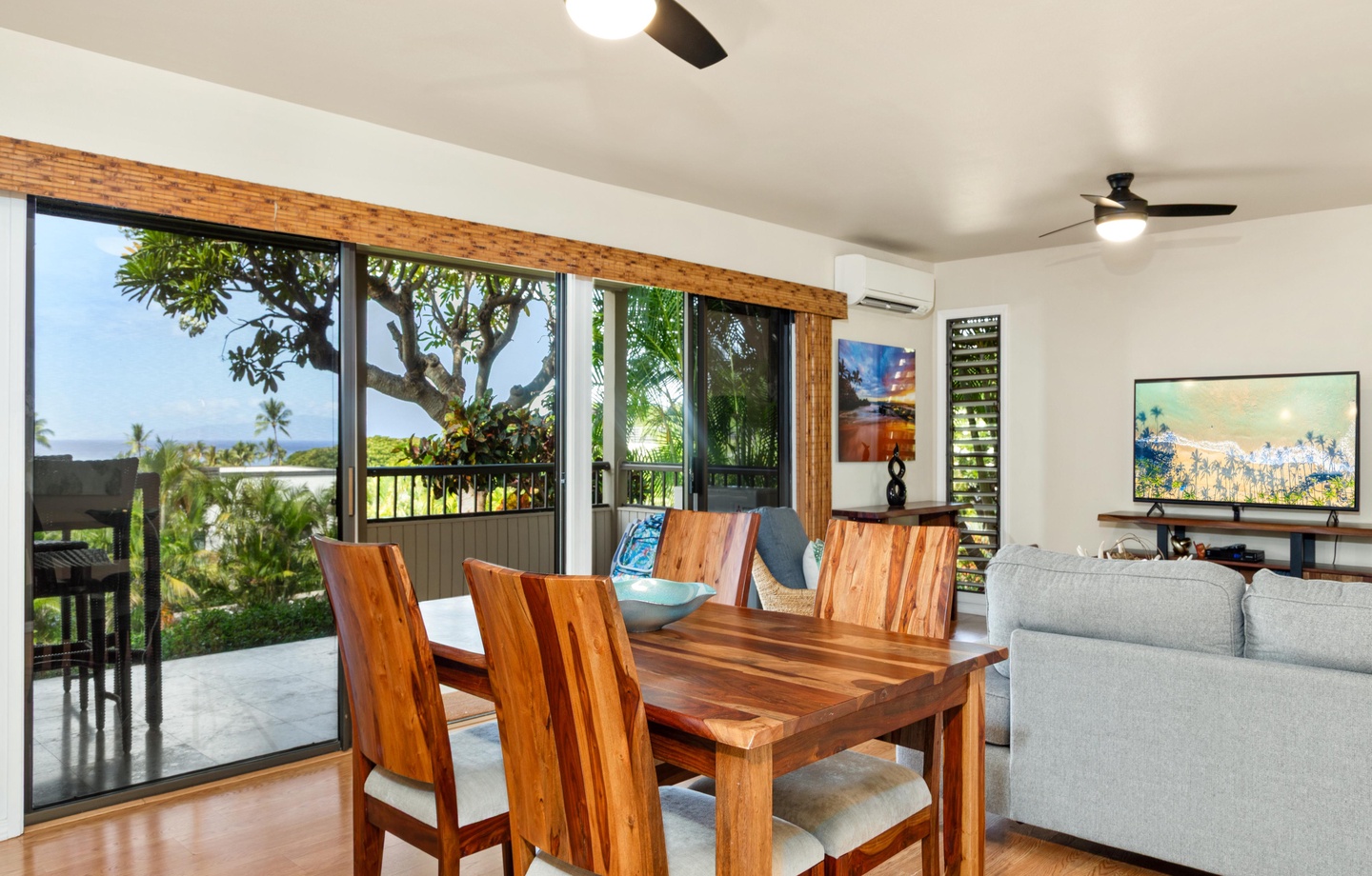 Gather around the stunning wood dining table where tropical breezes and ocean views frame your meals. The open layout invites you to relax and enjoy island living at its finest.