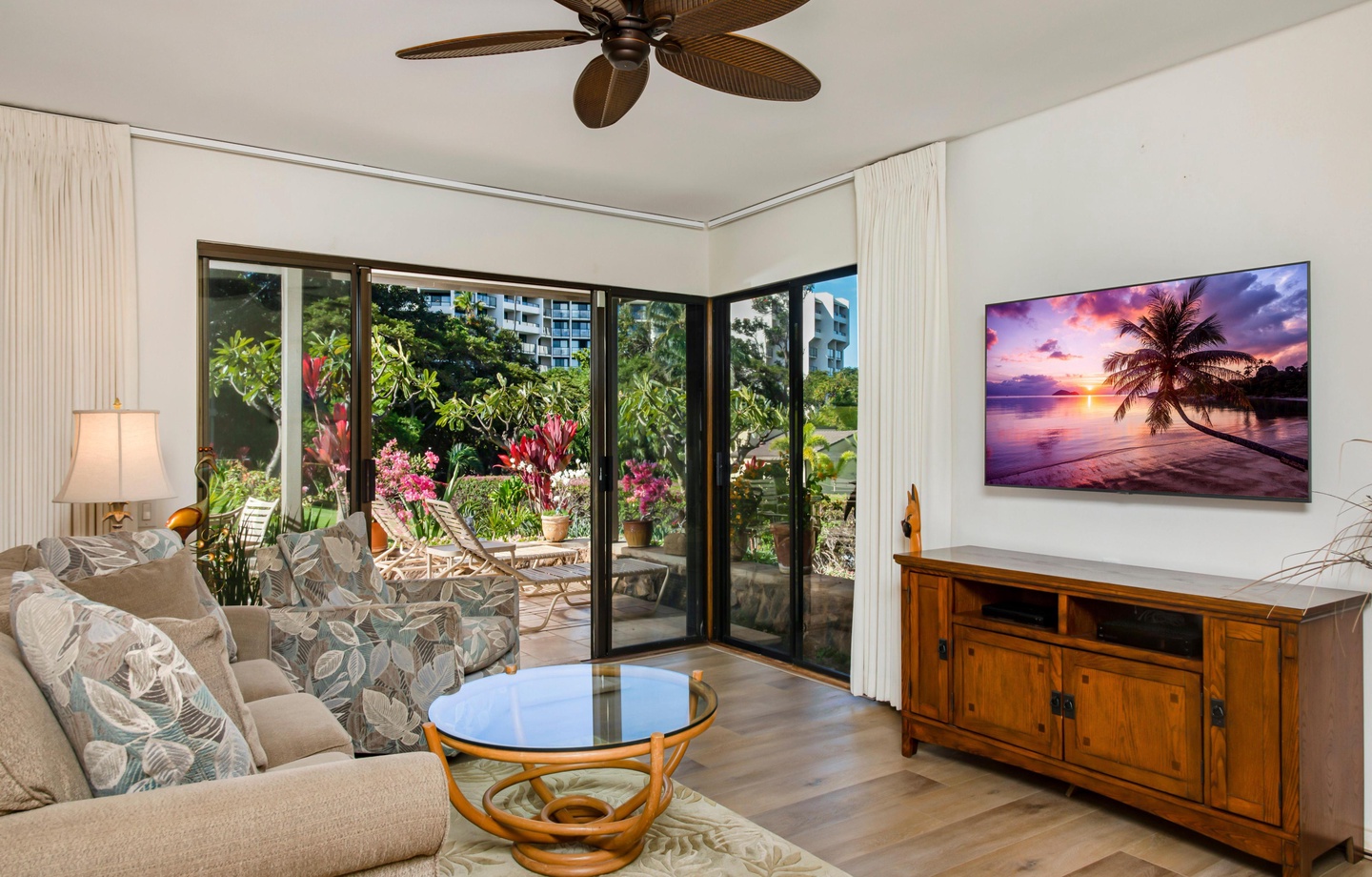 This 1025 sq.ft. ground-floor walkout condo has 2 full bathrooms and a large lanai opening straight onto the lawn and gardens — step-free from the door.