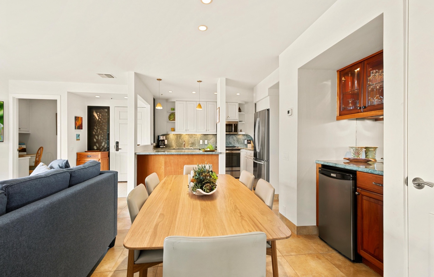 Gather around the spacious dining table where meals become memories. This bright, open-plan space flows seamlessly from living room to kitchen, perfect for your group to cook, dine, and relax together.