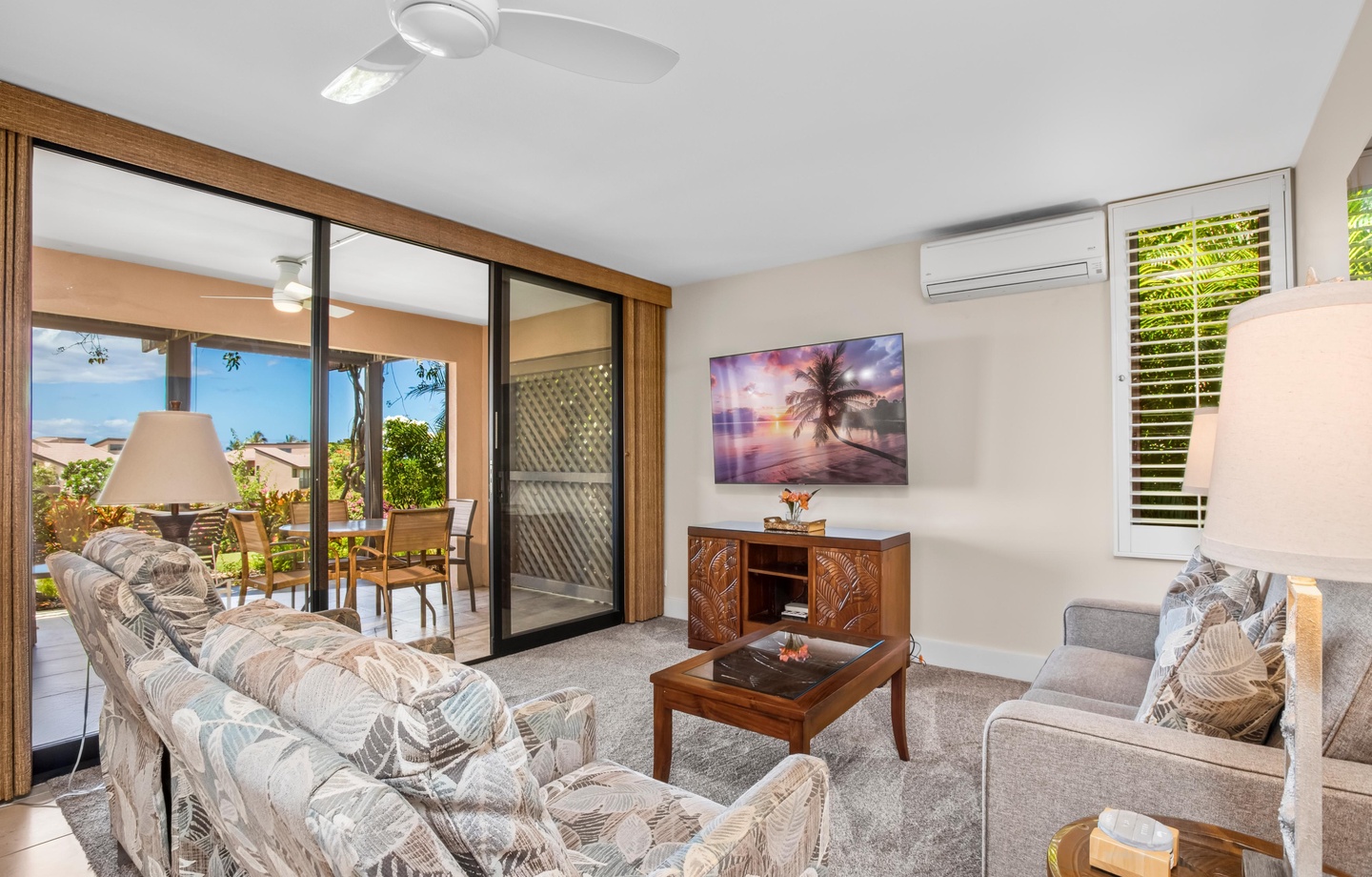 Relax in your bright, comfortable living space where tropical breezes and ocean glimpses await just beyond your private patio, perfect for morning coffee or sunset unwinding.