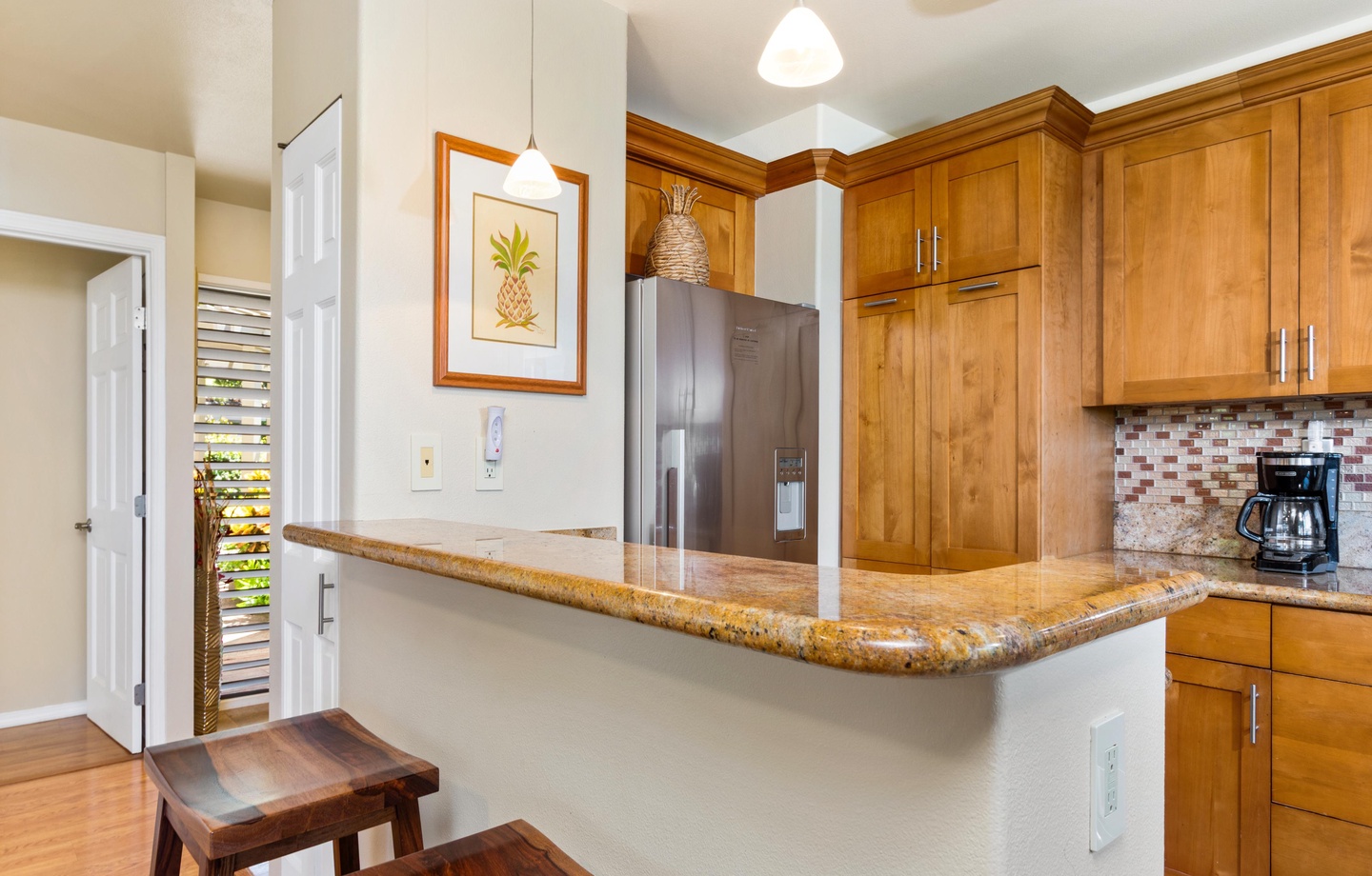 Your bright, well-equipped kitchen features warm wood cabinetry, granite countertops, and stainless steel appliances—perfect for preparing island-inspired meals or your morning coffee.