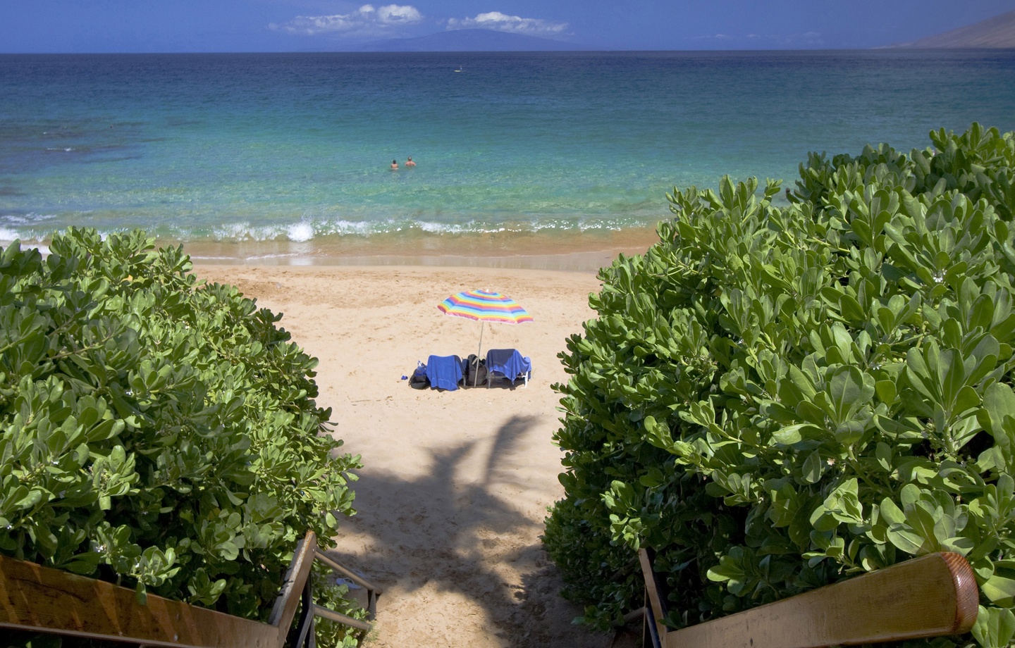 A shaded garden path leads straight to Keawakapu Beach — one of South Maui's calmest, least-crowded shores, with sea turtles gliding offshore within easy swimming distance.