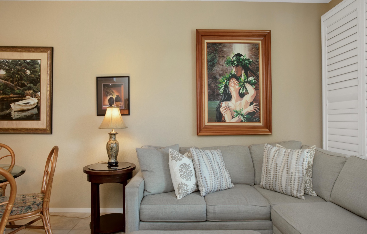 Sink into the plush sectional and unwind in your tranquil living space, where island-inspired art and gentle lamp light create the perfect atmosphere for relaxation.