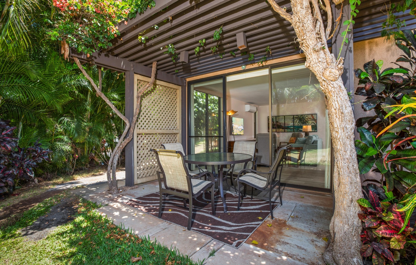 A spacious 1,000 sq.ft. 1-bedroom condo with 2 full bathrooms, and step-free ground-floor walkout access to a covered wrap-around lanai.