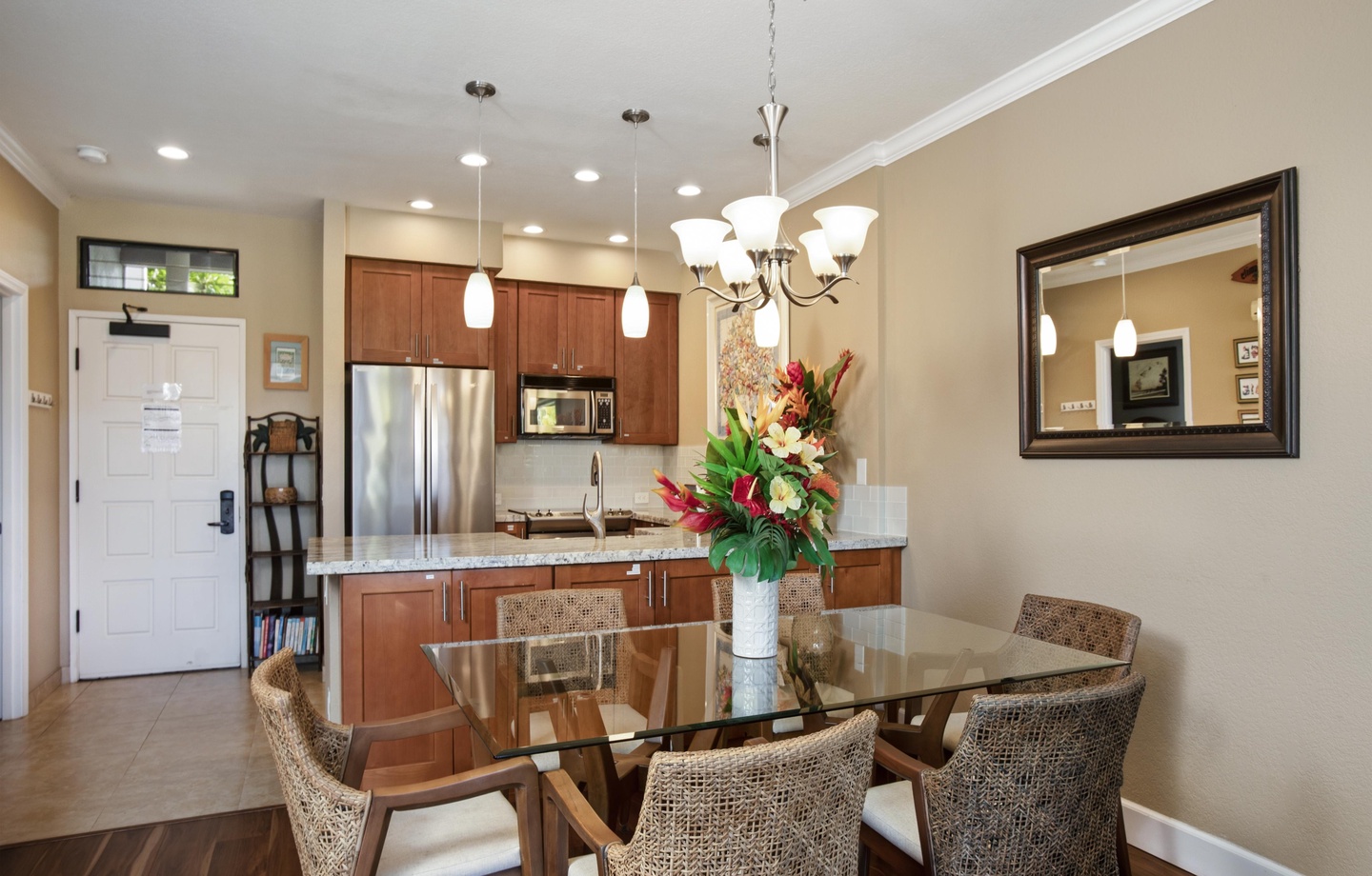 Gather around the elegant glass dining table, where warm lighting and an open layout create the perfect setting for your group meals and memorable conversations.