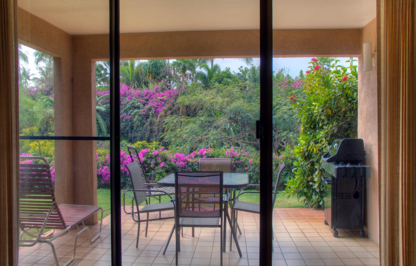 A spacious 1,090 sq.ft. 1-bedroom ground-floor condo offering step-free access and a private tropical garden view lanai with BBQ.