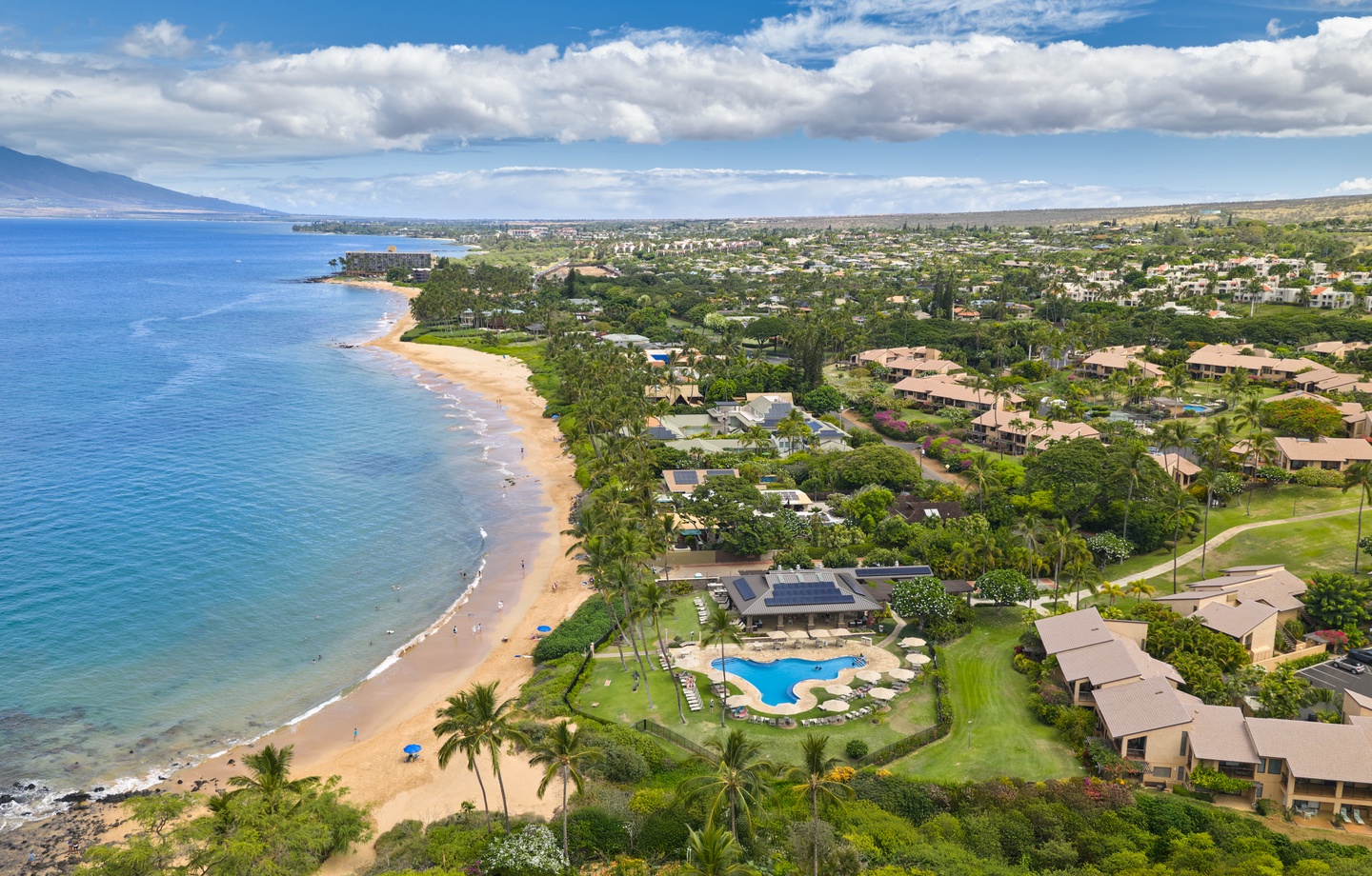 Beachfront resort community featuring direct beach access, oceanside pool, and lush tropical surroundings along Maui's scenic coastline.