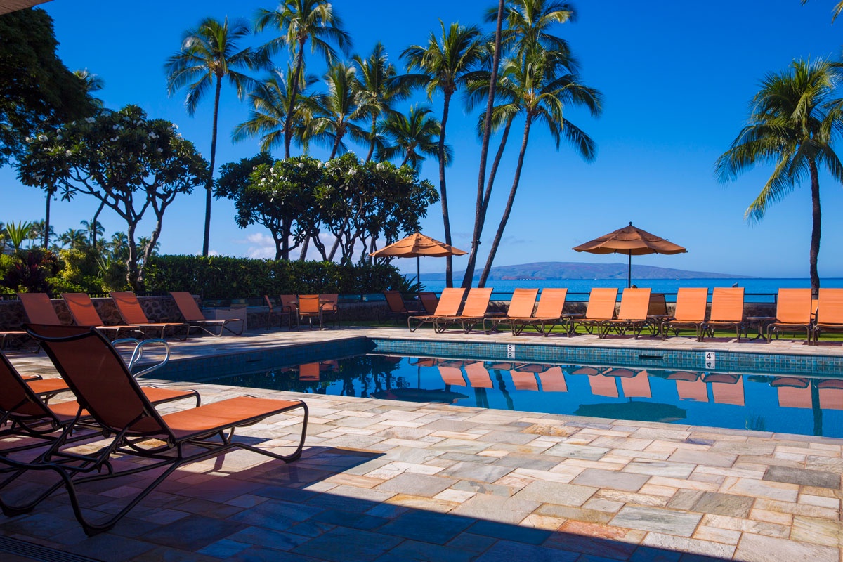 Relax in 2 large resort swimming pools surrounded by sun-drenched lounge chairs and tropical palms.