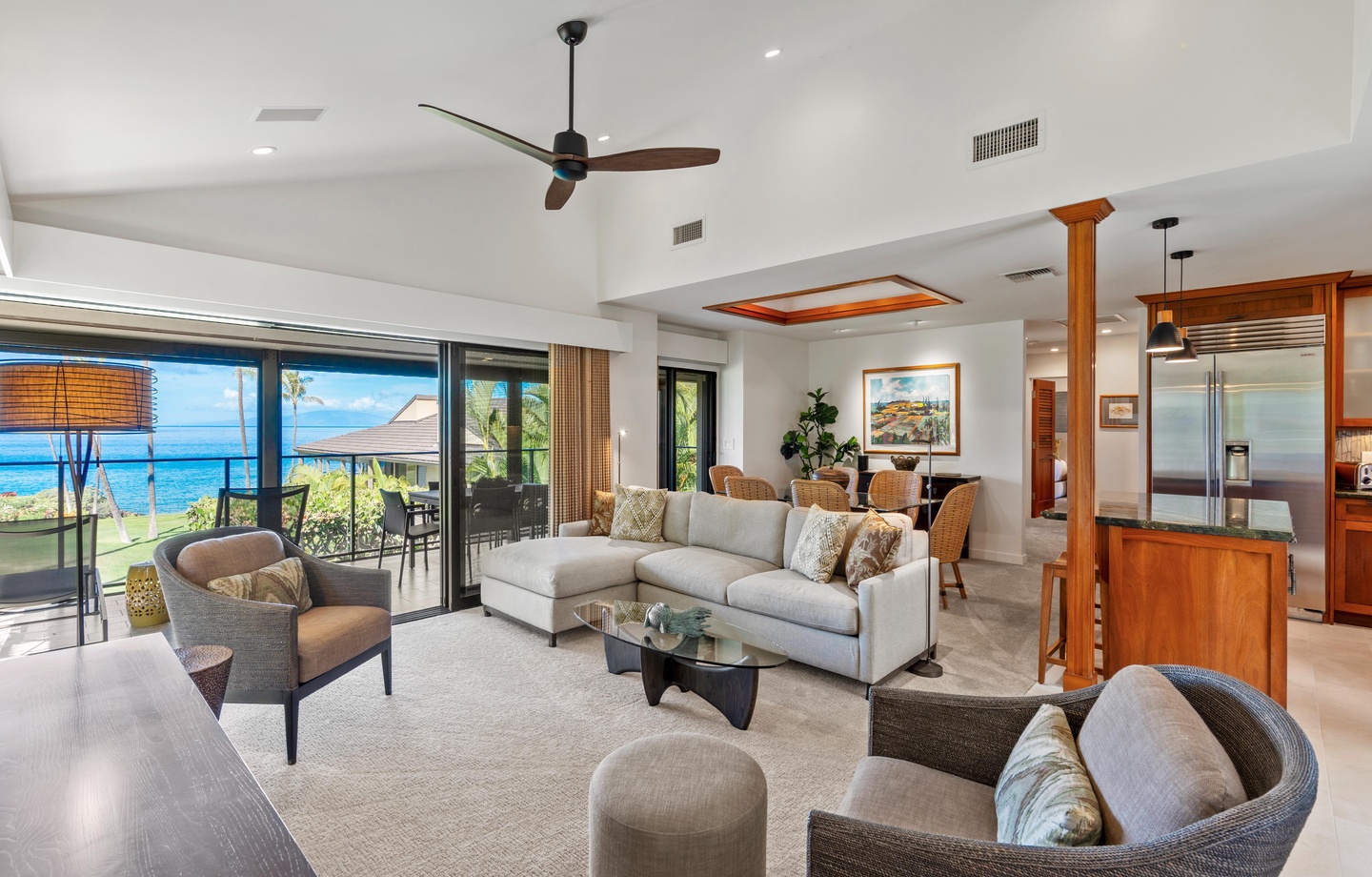 This recently renovated 1,336 sq.ft., 2-bedroom condo looks out over the lawn to open Pacific water, with accordion doors folding the living room onto the elevated lanai.
