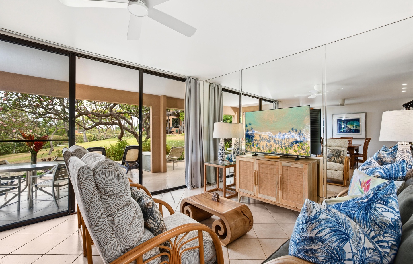 Step into your bright, breezy living room where tropical breezes and lush garden views create the perfect island retreat for relaxation and connection.