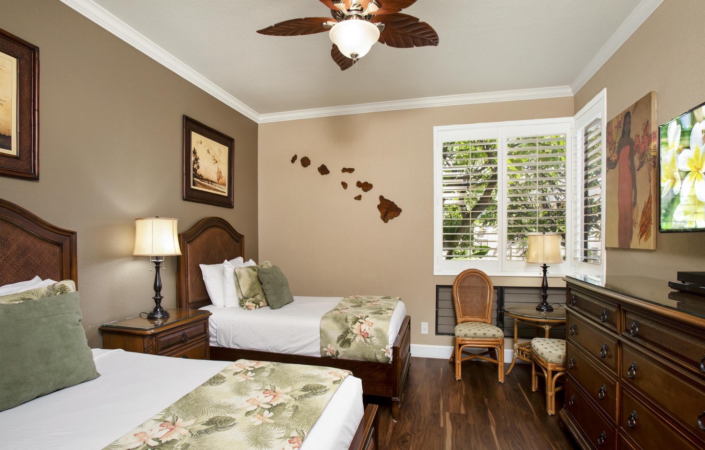 Drift off to sleep under the tropical ceiling fan in your cozy Hawaiian-themed bedroom, where twin beds with island-inspired linens invite you to unwind in comfort after a day of exploring.