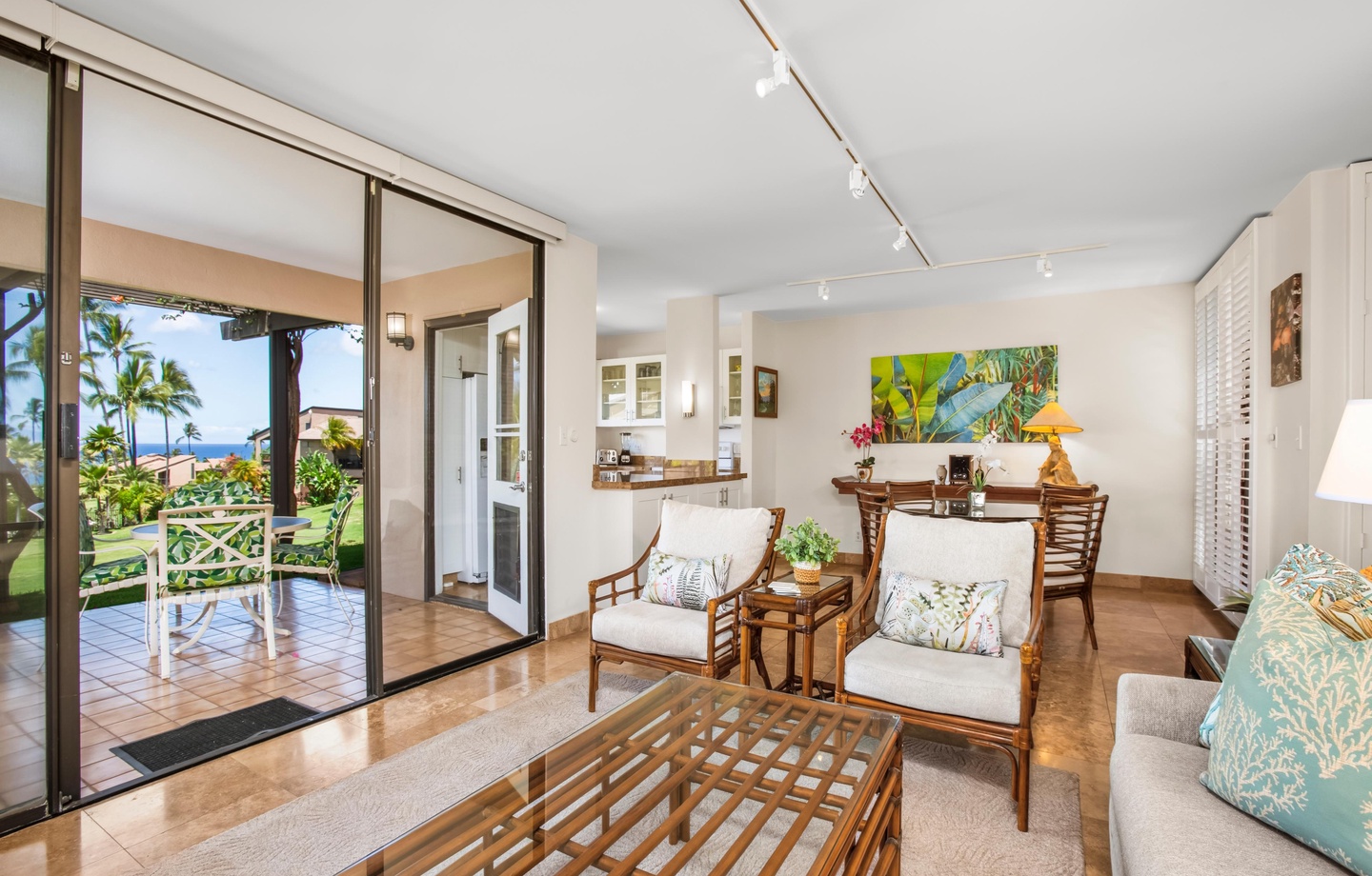 Step into your bright, island-inspired living space where tropical breezes and ocean views welcome you through sliding glass doors. Relax in comfort with stylish furnishings and easy access to your private lanai.