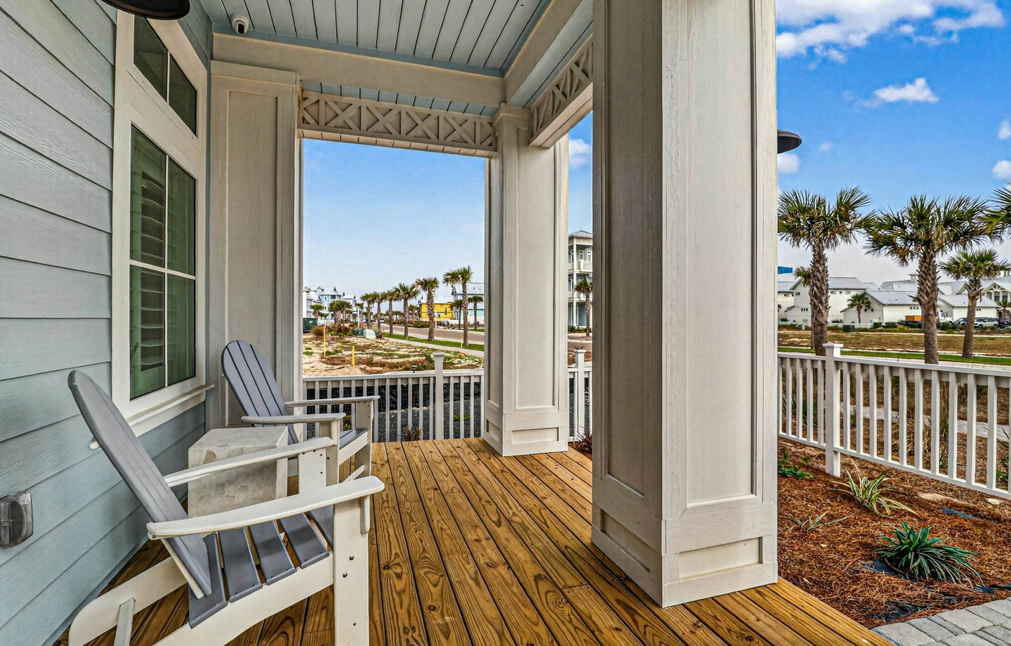 Settle into your private porch and breathe in the coastal air, with swaying palms and open skies framing your peaceful retreat.