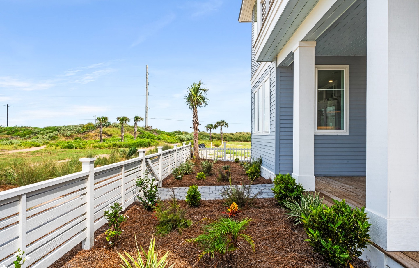 This charming coastal property sits just beyond the palms and dunes, offering easy access to the surrounding natural beauty. The building captures that classic beach-town character you'll love.