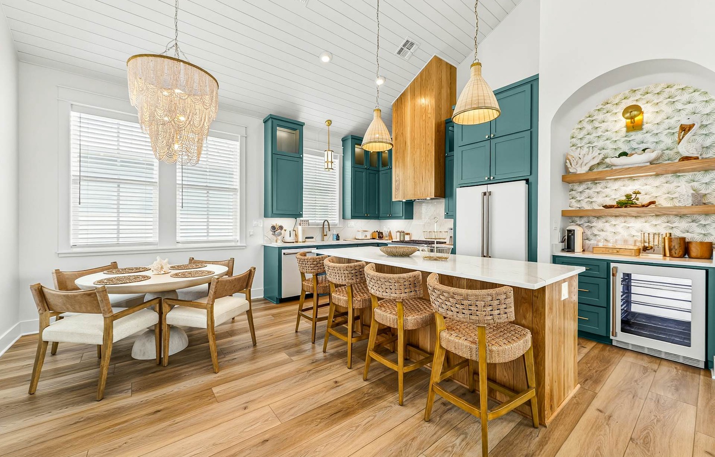 Gather around the spacious island and enjoy meals in your beautifully designed kitchen and dining area, where coastal charm meets modern comfort with elegant fixtures and abundant natural light.