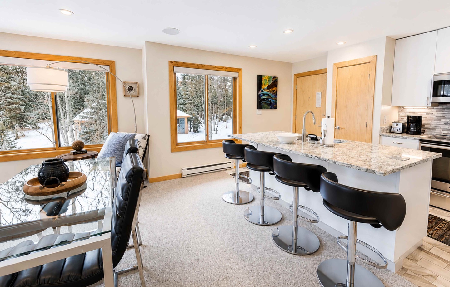 Gather with loved ones in this bright, modern space where granite countertops meet snowy mountain views. Sip your morning coffee at the breakfast bar while winter's beauty unfolds outside your windows.