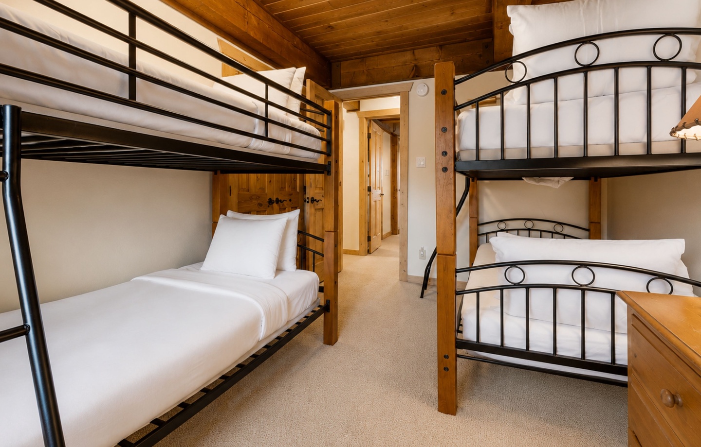 Your cozy bunk room features warm wood accents and comfortable beds, perfect for families or groups looking to make lasting memories together in the mountains.