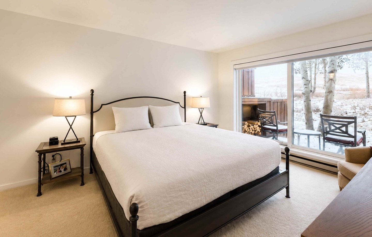 Wake up to serene winter views from your cozy bedroom, where soft linens and tranquil scenery create the perfect mountain retreat for your relaxation.