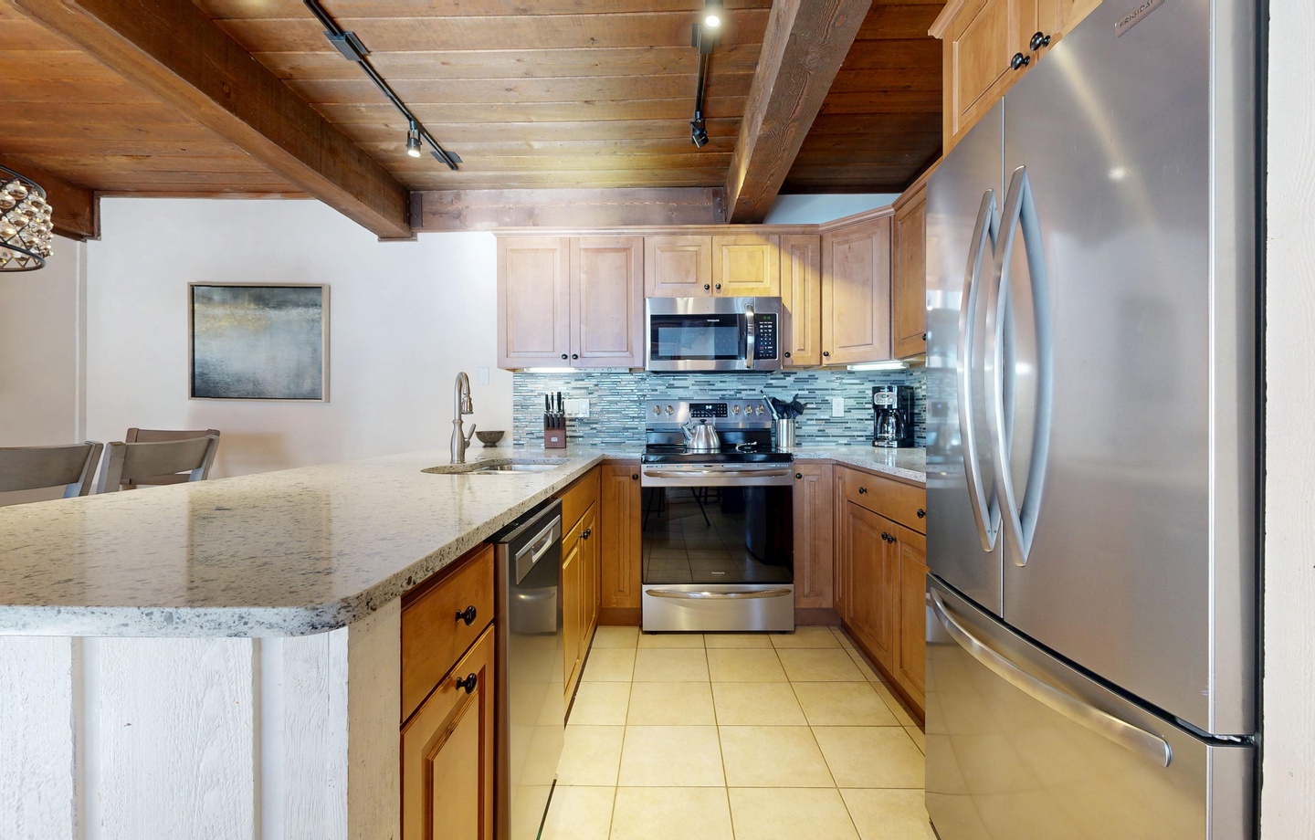 Your fully equipped kitchen features granite counters, stainless steel appliances, and stunning exposed beam ceilings for memorable meal preparation.