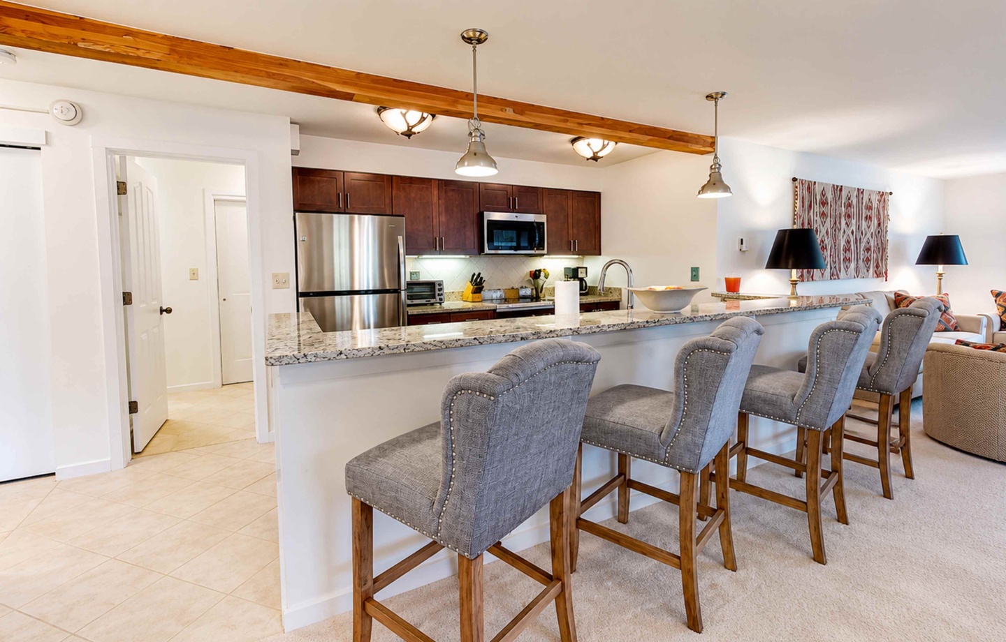 Gather around this spacious kitchen island where granite countertops and stainless appliances set the stage for your group meals and morning coffee rituals together.