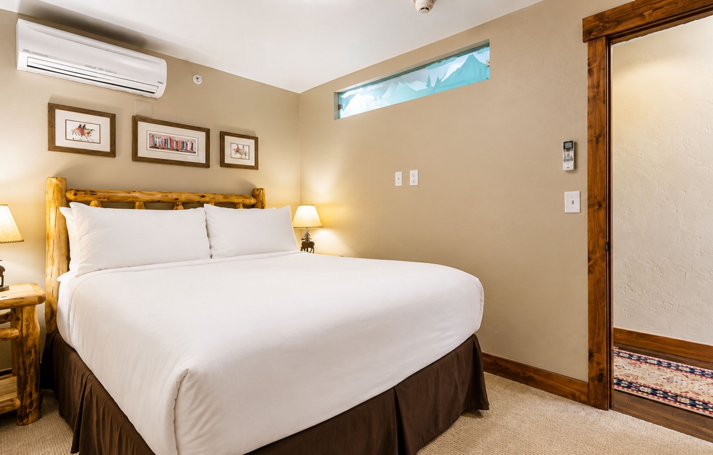 Sink into crisp linens and rustic mountain charm in your cozy bedroom, where warm wood accents and thoughtful details create your perfect alpine retreat.