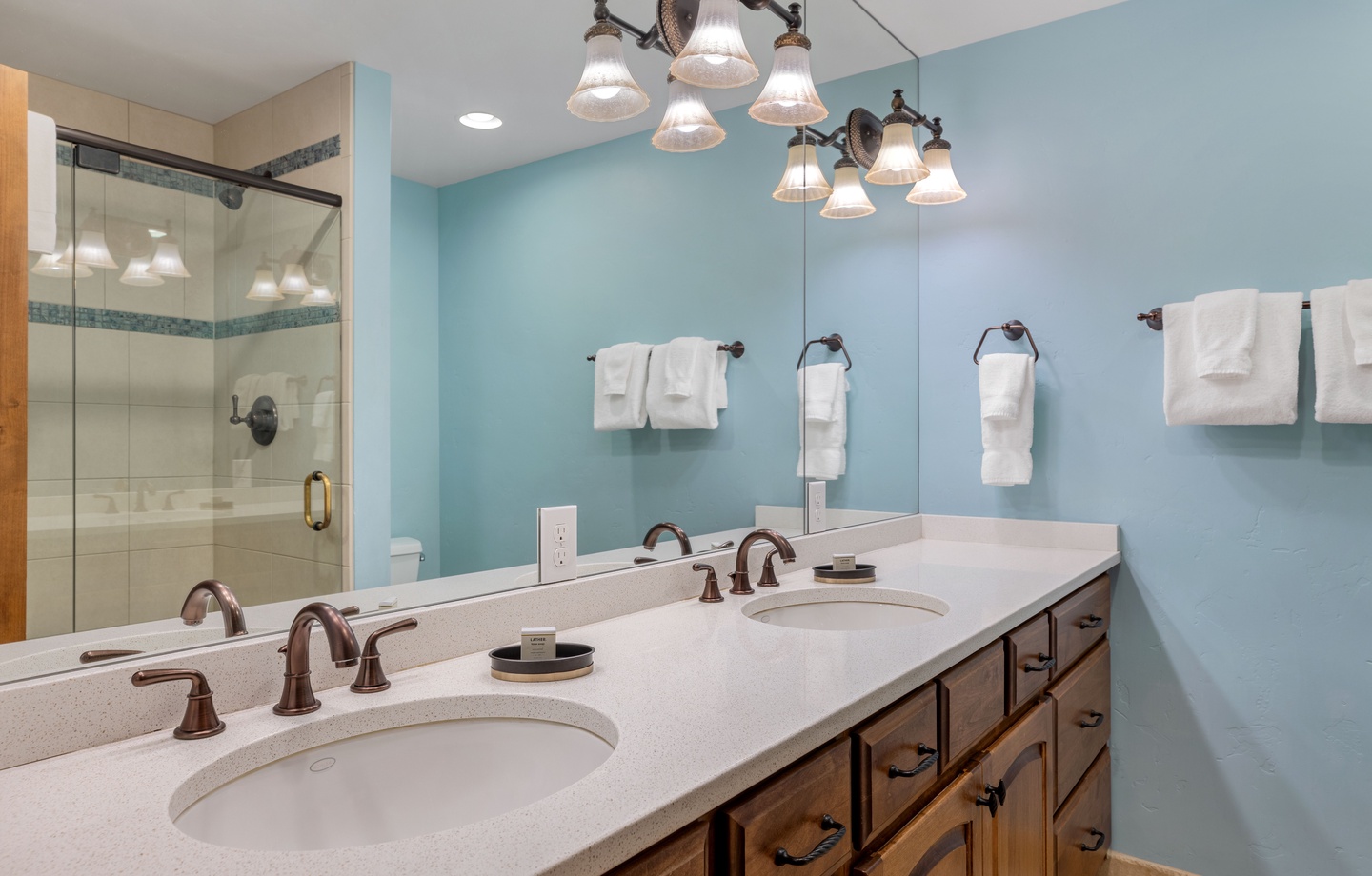Freshen up in your serene dual-sink bathroom, featuring a spacious walk-in shower and soothing coastal hues that invite relaxation after a day of adventure.