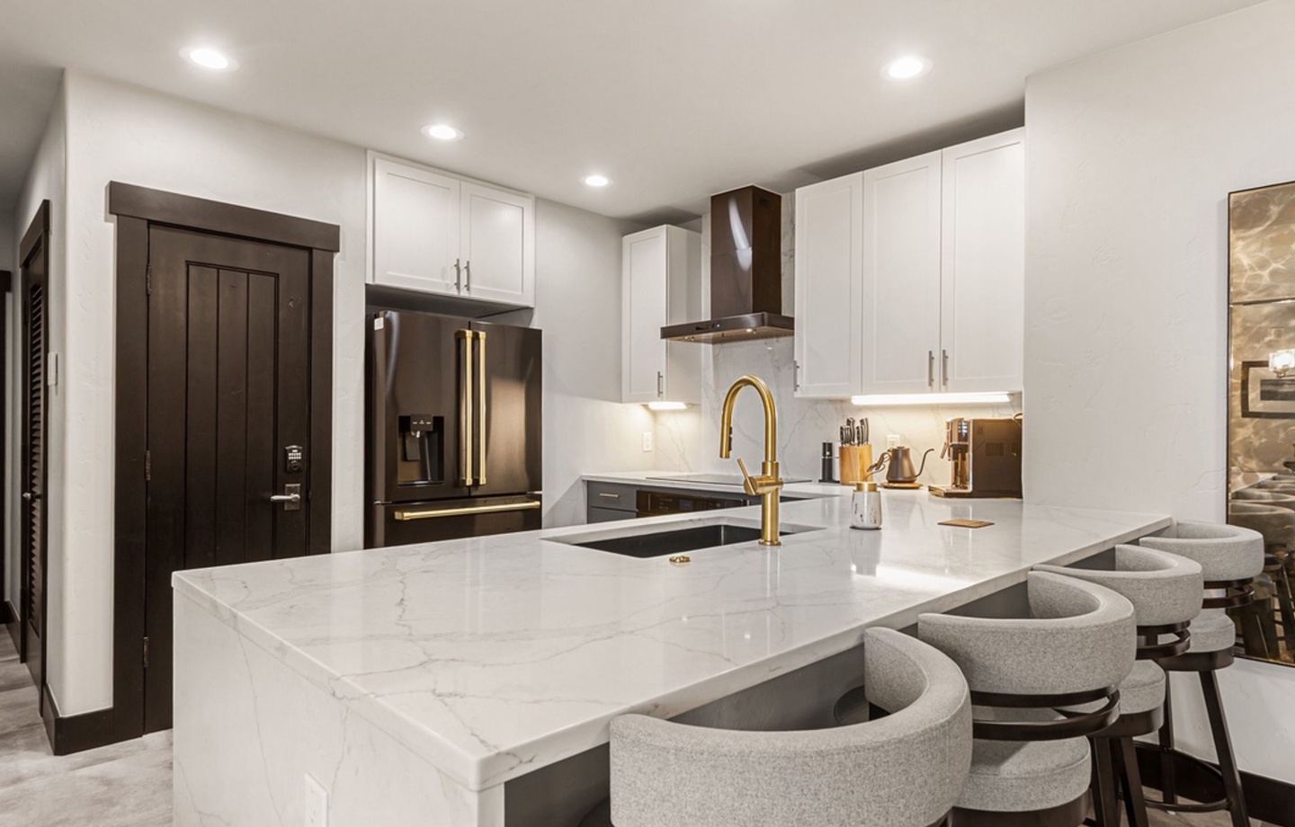 Step into your gleaming chef's kitchen, where marble counters and gold fixtures set the stage for memorable meals. Upscale appliances and a welcoming island make cooking feel like a true pleasure.