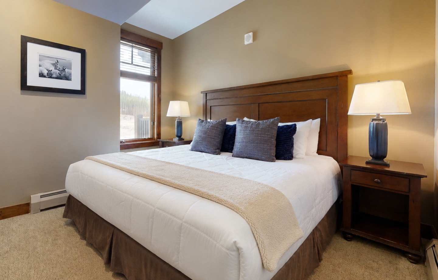 Slip into crisp linens and drift off in your peaceful bedroom retreat, where natural light and inviting warmth create the perfect sanctuary for rest.