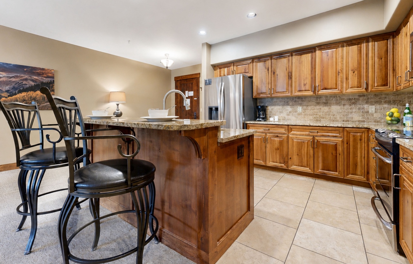 Your vacation starts in this welcoming kitchen, where warm wood cabinetry and a spacious island make meal prep a joy. Gather around with coffee or cocktails and feel right at home.