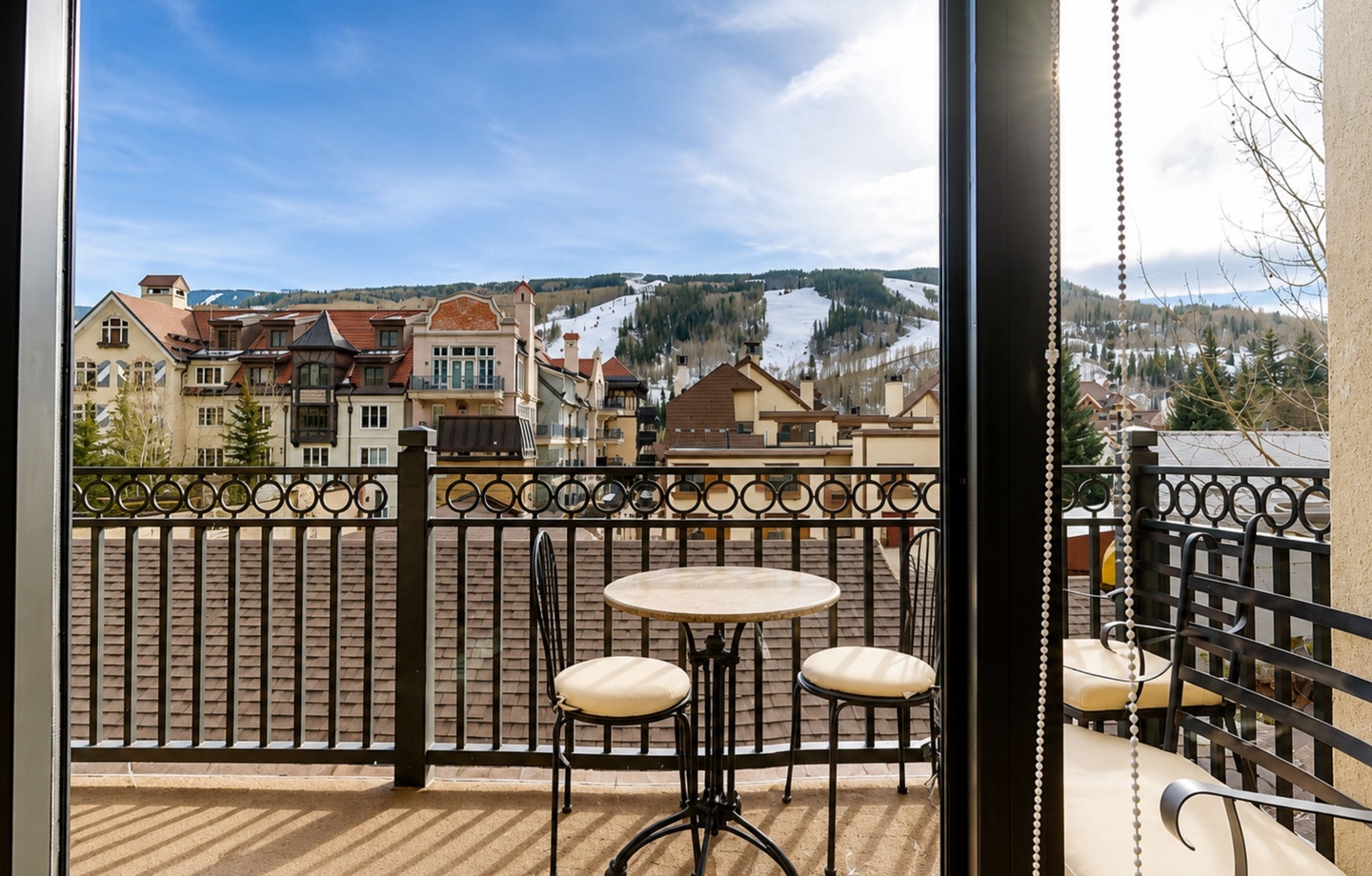 Your private balcony overlooks a charming alpine village and ski slopes, perfect for morning coffee or evening relaxation while taking in the mountain scenery.