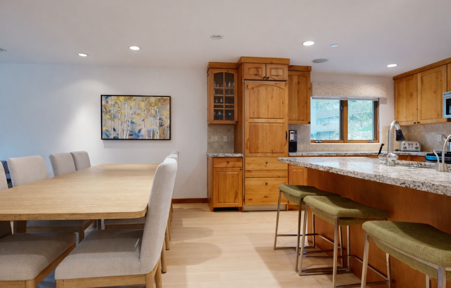 Gather around your spacious granite island or wooden dining table in this warm, modern kitchen perfect for memorable meals together.