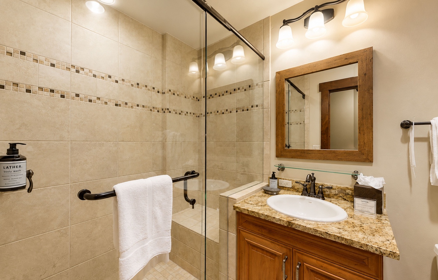 Refresh in your elegantly appointed bathroom with granite countertops, glass-enclosed shower, and warm wood accents throughout. Plush towels and premium amenities are ready for you.
