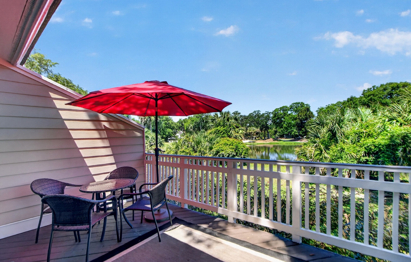 Sip your morning coffee at this private balcony table while soaking in peaceful lake and garden views. The shaded seating invites you to relax and reconnect with nature throughout your stay.