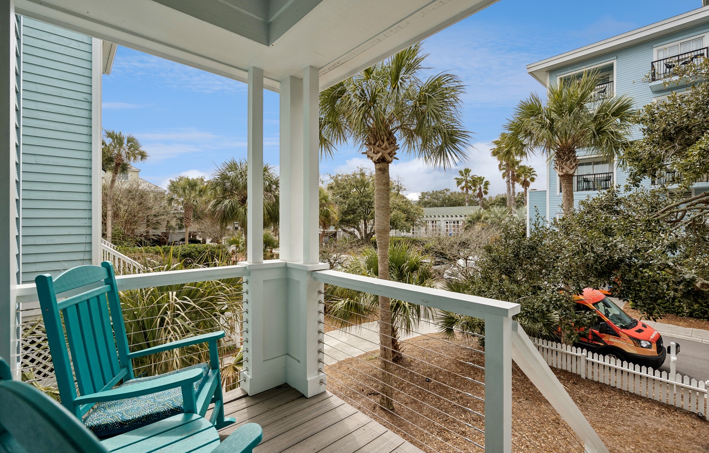 Sip your morning coffee on this peaceful covered balcony, surrounded by swaying palms and tropical coastal charm.